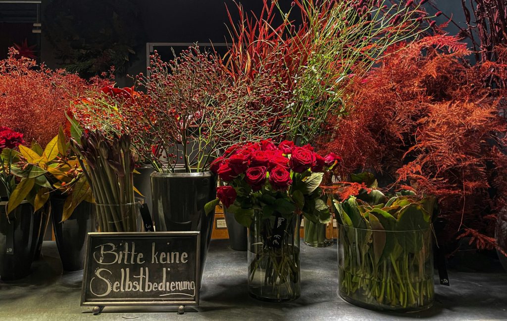 a bunch of vases filled with flowers on a table